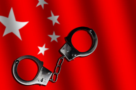 China flag and police handcuffs. The concept of crime and offenses in the countryの写真素材