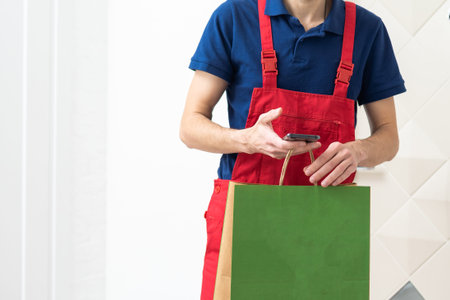 Diverse of paper containers for takeaway food. Delivery man is carrying