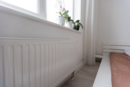 Modern electric heater on floor at home. Space for textの写真素材