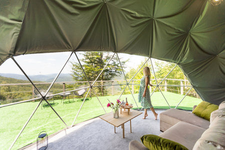 a woman enjoys solitude inside of a transparent bubble hotel.の写真素材