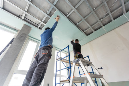 Two man help for ceiling house constructionの写真素材