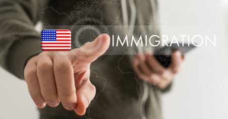 Man pointing at word IMMIGRATION and world map on dark blue background, closeup.の写真素材