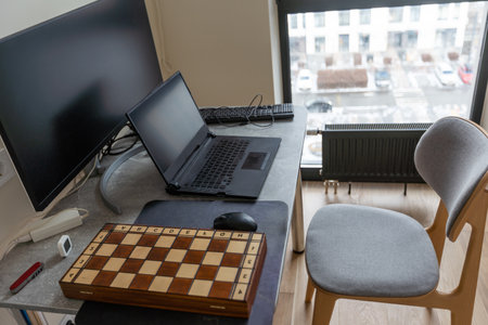 Laptop on the desk, mock up. Personal laptop computer on wood table in living room with modern interiorの写真素材