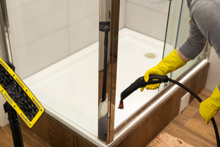 wet cleaning the bathroom with a steam cleanerの写真素材
