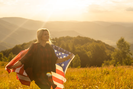 young beautiful woman holding USA flag.の写真素材