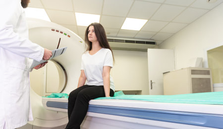 Radiologist with a female patient in the room of computed tomography.の写真素材
