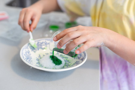 Children are learning and doing science experiments. Little girl playing science experiment for home schooling. Easy and fun science experiments for kids at home.の写真素材