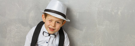 Young man sits on the laminate floor with black laptop. Top viewの写真素材
