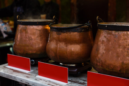 A giant pot full of hot mulled red wine with spices on the Advent Christmas marketの写真素材