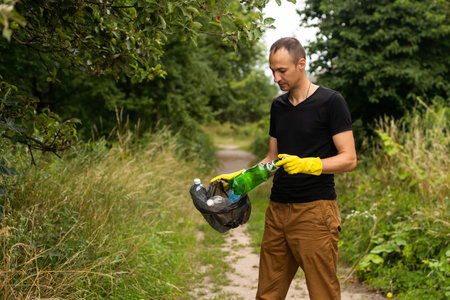 A young man, a nature conservationist, walks to collect trash in the mangrove forestの写真素材