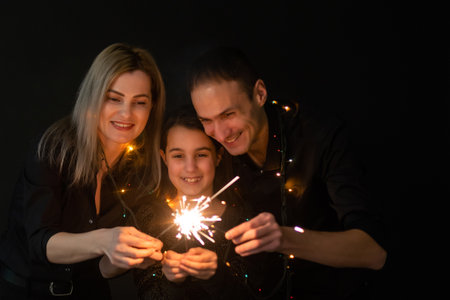 family with garland on a black backgroundの写真素材