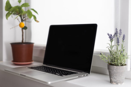 portable office desk with mock-up computer devices, supplies and decorations on white tableの写真素材
