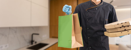 Diverse of paper containers for takeaway food. Delivery man is carrying pizzaの写真素材
