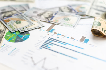 Accounting charts and graphs with us dollar bills pen calculator. Stock market graphsの写真素材