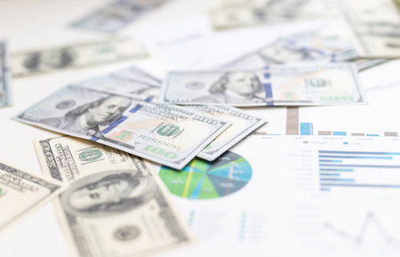 Accounting charts and graphs with us dollar bills pen calculator. Stock market graphsの写真素材