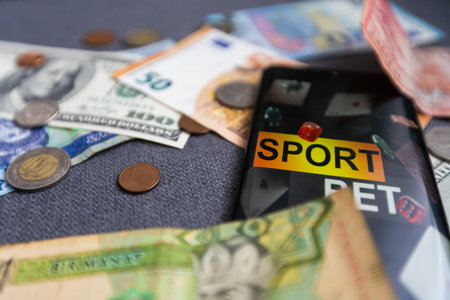 dollars and euros, smartphone with sports bet application