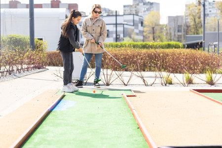 Family Time Playing Mini-Golf In The Summer