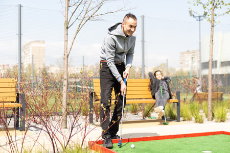 man playing mini golf. Summer season gameの写真素材