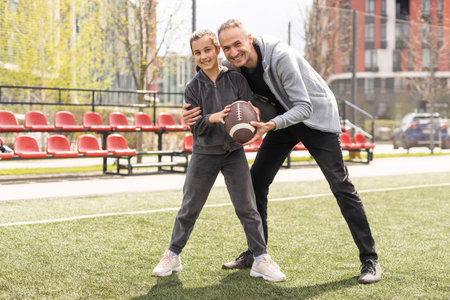 Family Playing American Football Together In Park.の写真素材
