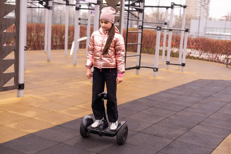 Personal eco transport, gyro scooter, smart balance wheel. A little girl riding a electric...