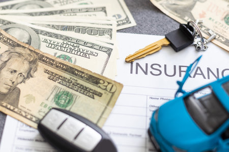 Car insurance form with car key and toy carの写真素材