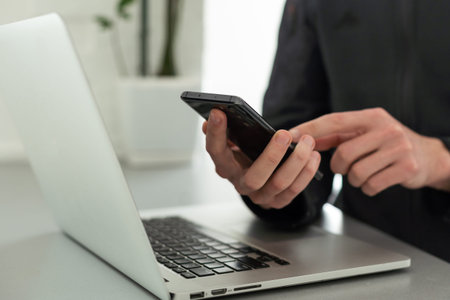 Businessman working with laptop, smartphone in hand. computer on the desk. Business concept.