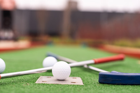 Mini golf close-up, colorful golf putters, ballsの写真素材