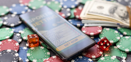 Mobile phone with bets, cards, chips, cubes and money dollars. Concept application for smartphone gambling, electronic casino onlineの写真素材