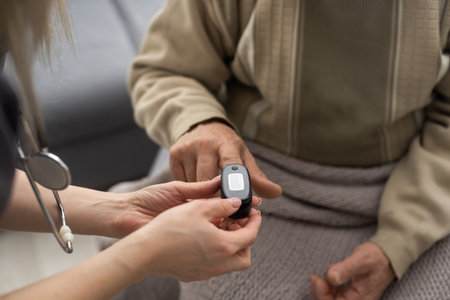 Measurement of oxygen level and pulse rate with a portable pulse oximeter - a man monitors his healthの写真素材