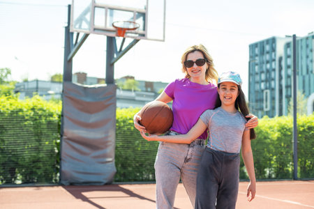 Mother and little daughter after basketball. Great job honey.の写真素材