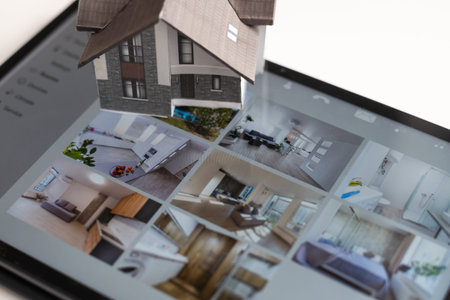 Small house model is on screen tablet and icons home electronics devices connecting with wireless....