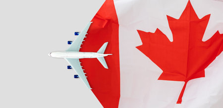 plane model with canadian flag on background, immigration conceptの写真素材