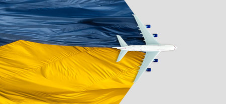 Toy airplane placed on the road painted the colors of the national flag of Ukraineの写真素材