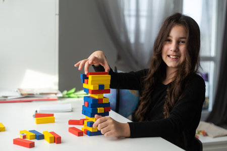 Cute little girl excites with wooden block gameの写真素材