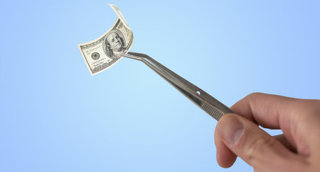 Money, dollar bill in tweezers