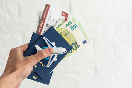hands holding passport and several banknotes