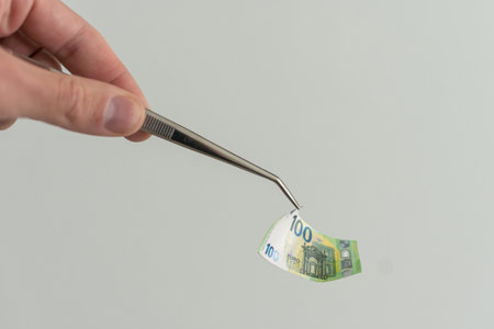 banknote euros money and tweezers.の写真素材