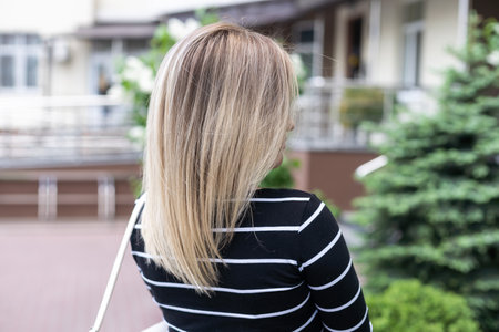 Portrait close up of young beautiful girl, on background spring streetの写真素材