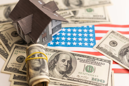 Small house on dollar bills backgroundの写真素材
