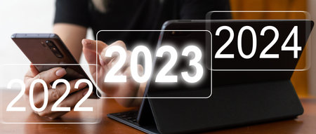 Businessman pointing to digital 2024 on virtual screen. Countdown to 2024 concept. Space for text....
