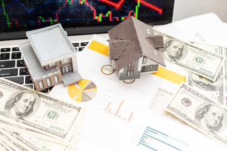 Small toy house is lies on money, bank form.