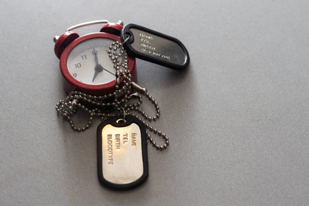 American military dog tags. badge with the name of a soldier. alarm clock