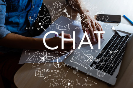 Young man sitting at table with laptopの写真素材