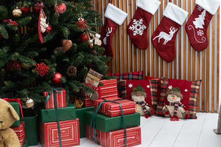 Beautiful Christmas gifts under fir tree on floor in room.