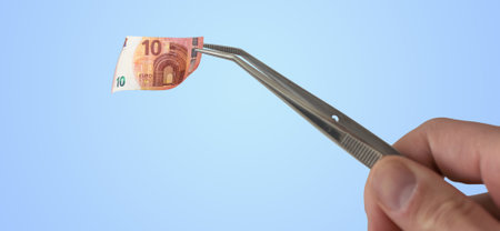 banknote euros money and tweezers.の写真素材
