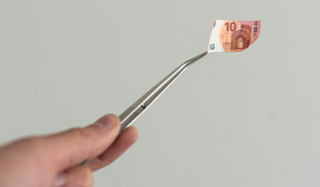 banknote euros money and tweezers.の写真素材