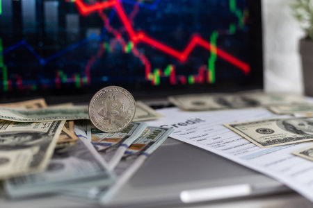 Cryptocurrency market is going down, is time to sell, red candles. The graph evolution of Bitcoin on a laptop and smartphone display showing the prices fallingの写真素材