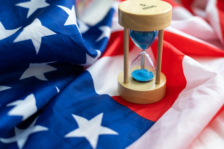 Hourglass and USA flag, soft focus, copy spaceの写真素材