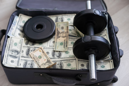 Suitcase with pile of dollars. Opened silver case with money. Better to have bank account. Part of city budget.の写真素材