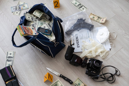 Black duffel bag full of dollar notes in criminal investigation unit, conceptual imageの写真素材